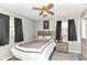 Cozy bedroom with a ceiling fan, comfortable bed, and rustic-style furniture at 1308 N Main St, Lapel, IN 46051