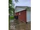 Side of red brick house with white siding, green lawn, and paved area at 1308 N Main St, Lapel, IN 46051