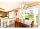 Eat-in kitchen with a wood table, bar seating, and sliding glass doors at 1308 N Main St, Lapel, IN 46051