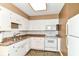 Cozy kitchen with white cabinets, tile backsplash, and modern appliances at 1308 N Main St, Lapel, IN 46051