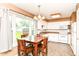 Eat-in kitchen featuring a dining table, tile floors, and white cabinets at 1308 N Main St, Lapel, IN 46051