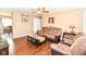 Cozy living room with hardwood floors, comfortable seating, ceiling fan and an abundance of natural light at 1308 N Main St, Lapel, IN 46051