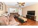 Inviting living room with hardwood floors, TV, comfortable seating, and a front door view at 1308 N Main St, Lapel, IN 46051