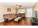 Inviting living room with hardwood floors, comfortable seating, and a front door view at 1308 N Main St, Lapel, IN 46051