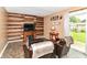 Warm living room with a fireplace, wood accent wall, comfortable seating, and direct access to the backyard at 1308 N Main St, Lapel, IN 46051