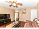 Inviting living room with hardwood floors, TV, and an open layout, ideal for entertaining and relaxing at 1308 N Main St, Lapel, IN 46051