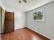 Bedroom with hardwood floors and a window showing a view of the trees at 145 S 7Th Ave, Beech Grove, IN 46107
