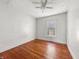 Bedroom featuring hardwood floors, ceiling fan, and natural light from a window at 145 S 7Th Ave, Beech Grove, IN 46107