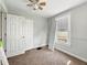 Bedroom features neutral walls, carpeted floors, and a ceiling fan with natural light from the window at 145 S 7Th Ave, Beech Grove, IN 46107