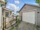 View of detached garage, providing ample storage and parking space with access to fenced yard at 145 S 7Th Ave, Beech Grove, IN 46107
