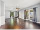 Bright living room has hardwood floors, a ceiling fan, large windows and crisp, neutral paint at 145 S 7Th Ave, Beech Grove, IN 46107