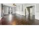 Living room boasts lots of natural light, hardwood floors, neutral paint, and a ceiling fan at 145 S 7Th Ave, Beech Grove, IN 46107