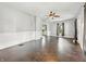 Bright living room features hardwood floors, neutral paint, ceiling fan, and large windows at 145 S 7Th Ave, Beech Grove, IN 46107