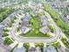 An aerial view of a neighborhood featuring mature trees, green lawns, and a cul-de-sac at 14931 W Black Wolf Run Dr, Carmel, IN 46033
