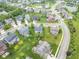 An aerial view of a beautiful neighborhood featuring mature trees, green lawns, and two small ponds at 14931 W Black Wolf Run Dr, Carmel, IN 46033