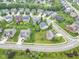 An aerial view of homes in a suburban neighborhood with mature trees and well-manicured lawns at 14931 W Black Wolf Run Dr, Carmel, IN 46033