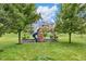Backyard featuring a wooden play set with slide and swing on a lush green lawn at 14931 W Black Wolf Run Dr, Carmel, IN 46033