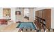 Recreational space with game table and foosball leading to a workout area through sliding barn doors at 14931 W Black Wolf Run Dr, Carmel, IN 46033