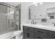 Modern bathroom featuring a double vanity with sleek fixtures, a walk-in shower with gray tiling, and contemporary design elements at 14931 W Black Wolf Run Dr, Carmel, IN 46033