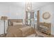Cozy bedroom features a gold dresser, chandelier, and neutral decor at 14931 W Black Wolf Run Dr, Carmel, IN 46033