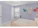 Inviting lavender bedroom showcasing a comfortable bed, a serene decor, and a window with blinds creating a calm and peaceful atmosphere at 14931 W Black Wolf Run Dr, Carmel, IN 46033