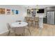 Cozy dining area features modern table and chairs, plus a bar with seating and stainless steel refrigerator at 14931 W Black Wolf Run Dr, Carmel, IN 46033