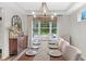 Dining room with table and seating for eight, chandelier, and a decorative window overlooking the yard at 14931 W Black Wolf Run Dr, Carmel, IN 46033