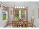 Dining room with a wood table, chairs, and large windows offering a view of the outdoors at 14931 W Black Wolf Run Dr, Carmel, IN 46033