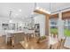 Open-concept dining area featuring a wood table, natural light, and view of the backyard at 14931 W Black Wolf Run Dr, Carmel, IN 46033