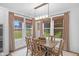 Dining room with wood table, natural light, neutral decor, and large windows with backyard views at 14931 W Black Wolf Run Dr, Carmel, IN 46033