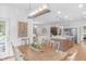 Open-concept dining room with wood table and chairs, flowing into living room and kitchen at 14931 W Black Wolf Run Dr, Carmel, IN 46033