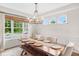 Dining area with table and bench seating, modern chandelier, and lots of natural light at 14931 W Black Wolf Run Dr, Carmel, IN 46033