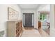Bright and airy entryway with console table, decorative mirror, and wood-look floors at 14931 W Black Wolf Run Dr, Carmel, IN 46033