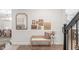 Charming foyer with decorative wall trim, hardwood floors, and a stylish bench complemented by curated artwork and elegant decor at 14931 W Black Wolf Run Dr, Carmel, IN 46033