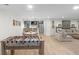Spacious basement game room with a foosball table, kitchenette, dining area, and comfortable lounge seating at 14931 W Black Wolf Run Dr, Carmel, IN 46033