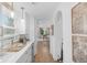 Bright hallway with white cabinets, countertops, and an arched doorway view of the dining room at 14931 W Black Wolf Run Dr, Carmel, IN 46033