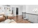 Hallway featuring hardwood floors, bookshelves, and laundry room access at 14931 W Black Wolf Run Dr, Carmel, IN 46033