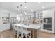 Open kitchen featuring a large island, stainless steel appliances, and modern white cabinetry at 14931 W Black Wolf Run Dr, Carmel, IN 46033