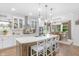 Gourmet kitchen with a large island, eat-in bar, stainless appliances, and modern pendant lighting at 14931 W Black Wolf Run Dr, Carmel, IN 46033