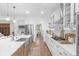Bright kitchen with stainless steel appliances, farmhouse sink, and white cabinets with gold hardware at 14931 W Black Wolf Run Dr, Carmel, IN 46033