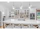 Spacious kitchen island with white countertops, seating, and stylish lighting fixtures at 14931 W Black Wolf Run Dr, Carmel, IN 46033