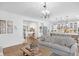 Living room open to kitchen features a chandelier and hardwood floors at 14931 W Black Wolf Run Dr, Carmel, IN 46033
