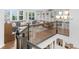 Bright living room with custom built-ins, a cozy seating area, and a staircase with decorative iron railings at 14931 W Black Wolf Run Dr, Carmel, IN 46033