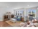 Inviting living room with abundant natural light, featuring a comfortable blue sofa, and a cozy rug, creating a perfect relaxing space at 14931 W Black Wolf Run Dr, Carmel, IN 46033