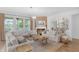 Bright living room featuring a fireplace, hardwood floors, and neutral furnishings at 14931 W Black Wolf Run Dr, Carmel, IN 46033