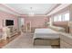 Bright main bedroom with pink walls, hardwood floors, a chandelier and large windows at 14931 W Black Wolf Run Dr, Carmel, IN 46033