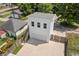 Aerial view of a two-story detached garage with an adjacent home and mature landscaping at 1627 Pleasant St, Indianapolis, IN 46203