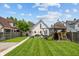 Spacious backyard with lush lawn, wooden playset, and privacy fence at 1627 Pleasant St, Indianapolis, IN 46203