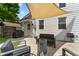 Backyard patio with lounge furniture, awning, and modern design at 1627 Pleasant St, Indianapolis, IN 46203