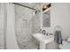 Bathroom featuring a marble-tiled shower, modern vanity and decorative lighting at 1627 Pleasant St, Indianapolis, IN 46203